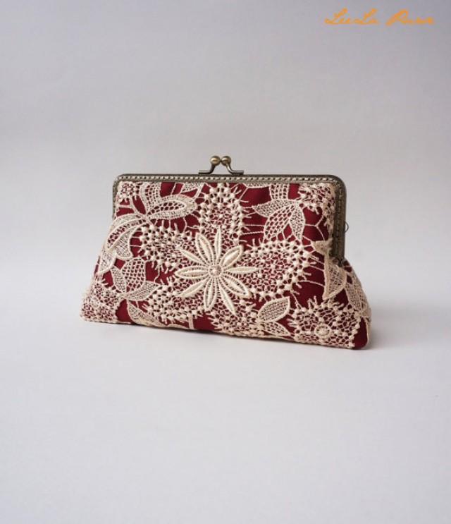 burgundy and gold clutch bag