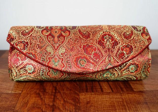 burgundy and gold clutch bag