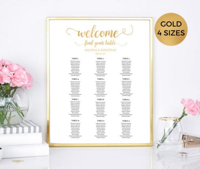 A White And Gold Wedding Seating Chart On A Easel